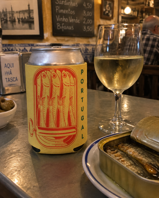 Portugal Sardine Can Yellow koozy on a tasca counter with a sardine tin and vinho verde