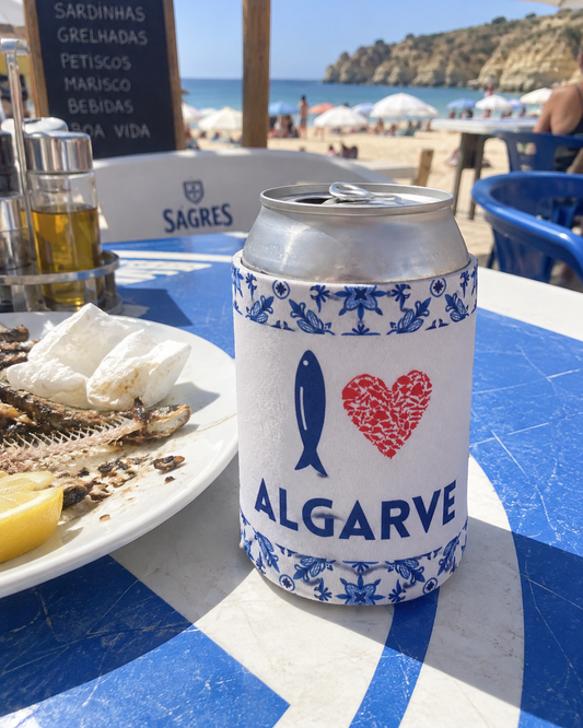 I Love Algarve White koozy on a beach cafe table with grilled sardines