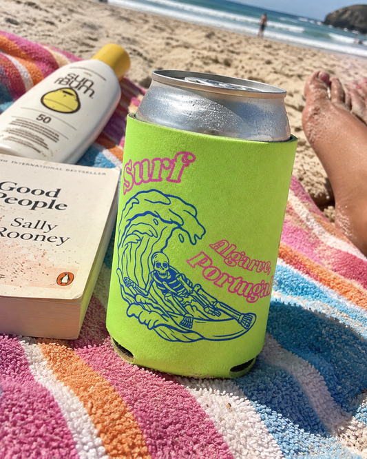 Surf Algarve Neon Yellow koozy on a striped beach towel in the sand